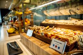 Delta Sky Club hot food and snack display — bakery items, fresh pastries, and chef-curated bites