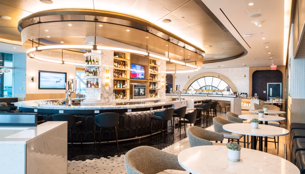 Delta Sky Club main lounge interior with seating, soft lighting and skyline views